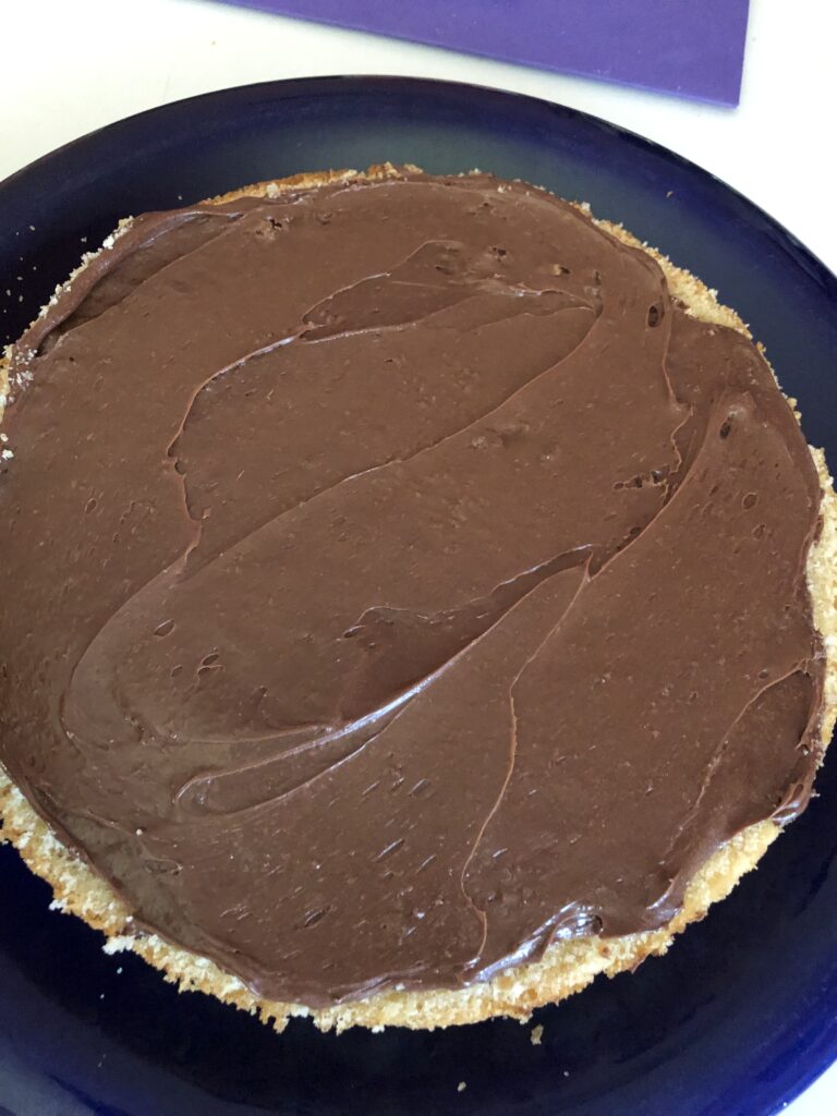 chocolate icing on a torted cake layer